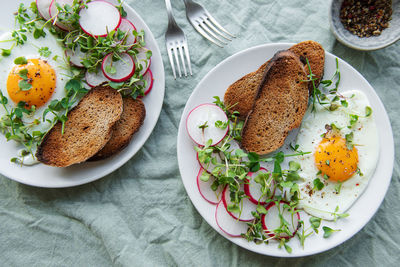 Delicious gourmet breakfast. rye bread with fried egg, freshly ground pepper and salad 