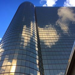 Low angle view of modern building against blue sky