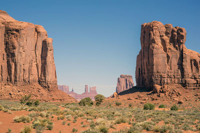 View of rock formations on landscape against clear sky
