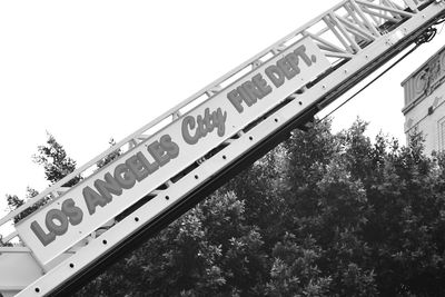 Low angle view of signboard against sky