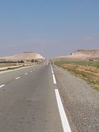 Empty road against clear sky