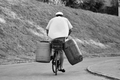 Rear view of man riding bicycle