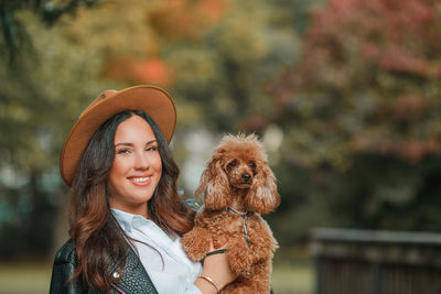 Portrait of young woman with dog
