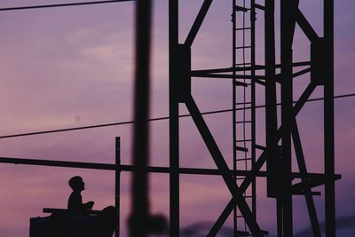 Low angle view of silhouette metal structure against sky