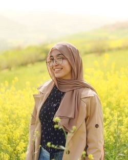 Young woman standing on field