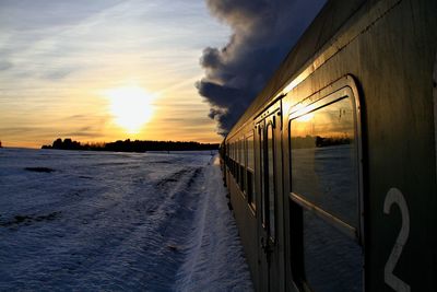 Scenic view of train against sky during sunset