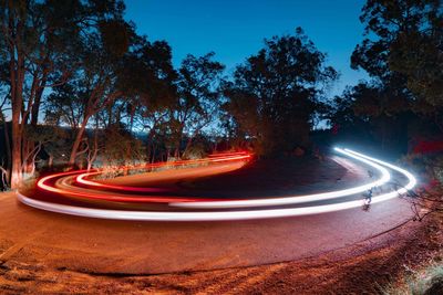 Light trails on road in city at night