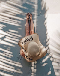 Low section of woman with shadow on wall