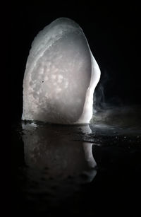 Close-up of water flowing over black background