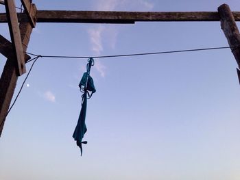 Low angle view of clothes hanging on clothesline against clear sky
