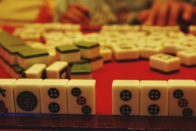 Midsection of man playing mahjong