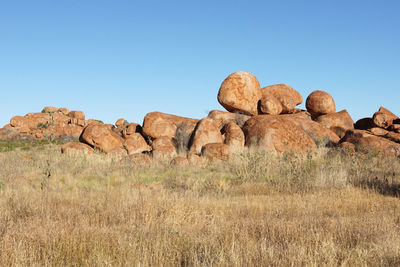 Rock formations on landscape against clear sky