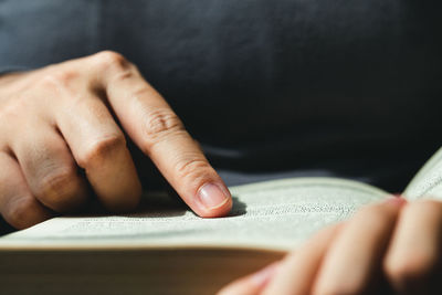 Close-up of hand holding book