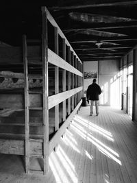 Rear view of man walking in building