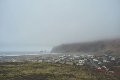 Scenic view of landscape and sea against sky