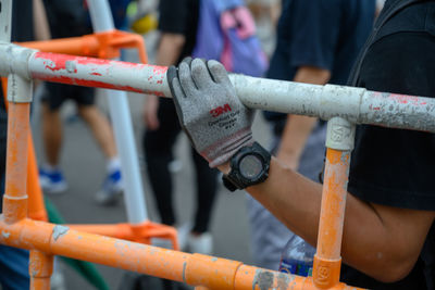 Close-up of woman holding railing