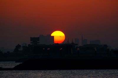 Silhouette of building against sky during sunset