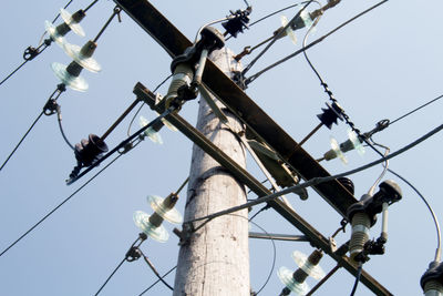Low angle view of electricity pylon against sky