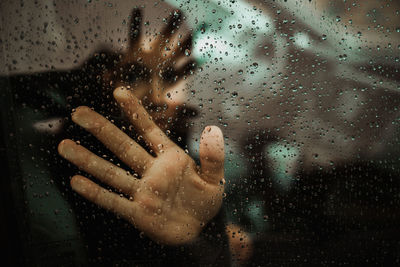 Close-up of girl touching car window