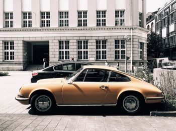 Car on street against buildings in city