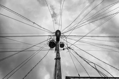 Low angle view of electricity pylon against sky