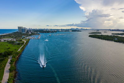 High angle view of buildings by sea against sky