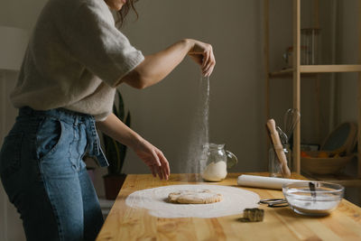 Side view of woman preparing food on table