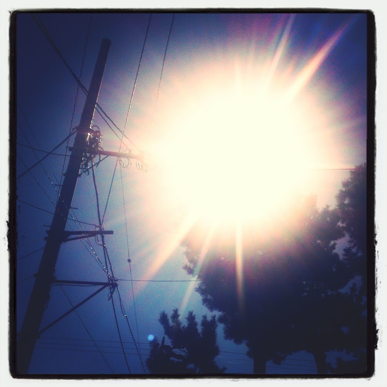 sun, sunbeam, lens flare, sunlight, transfer print, bright, power line, low angle view, sky, sunny, silhouette, auto post production filter, electricity pylon, nature, electricity, tranquility, back lit, blue, beauty in nature, power supply