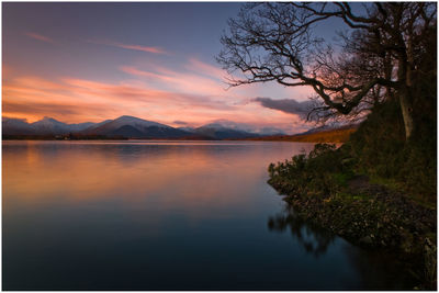 Scenic view of lake against sky during sunset