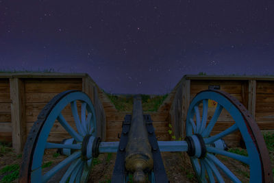 Built structure on field against sky at night