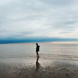 Silhouette of woman standing on beach