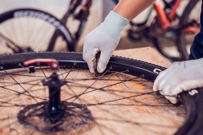 Close-up of man with bicycle on metal