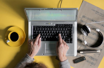 High angle view of man using laptop on table