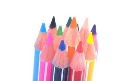 Close-up of multi colored pencils against white background