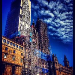 Low angle view of modern buildings against blue sky