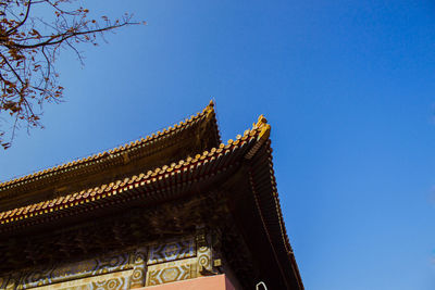 Low angle view of temple against clear blue sky