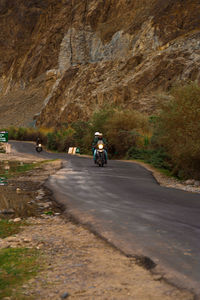 Man riding motorcycle on road