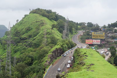 High angle view of road amidst trees against sky