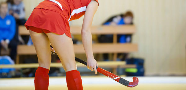 Midsection of female athlete playing hockey