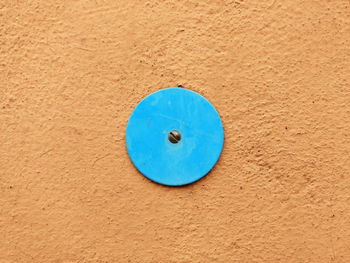 Circular plate mounted on orange wall
