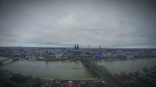 Cityscape against cloudy sky