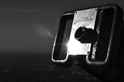 Close-up of binoculars against sky