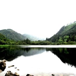 Scenic view of lake and mountains against clear sky