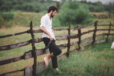 Full length of young man standing on field