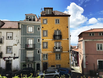Buildings in town against sky