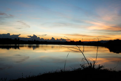 Scenic view of lake against romantic sky at sunset