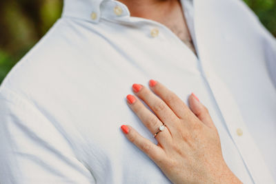 Cropped hand of woman touching chest