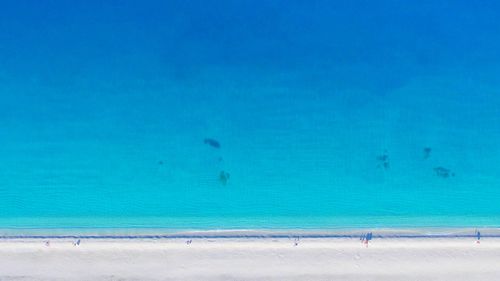 Scenic view of beach against blue sky