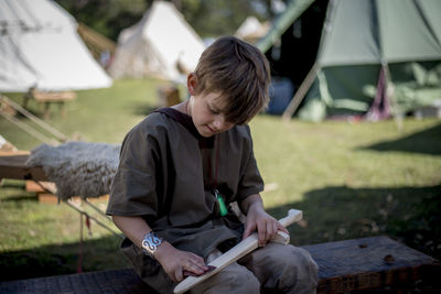 Boy making wooden sword