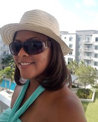 Portrait of smiling young woman wearing sunglasses